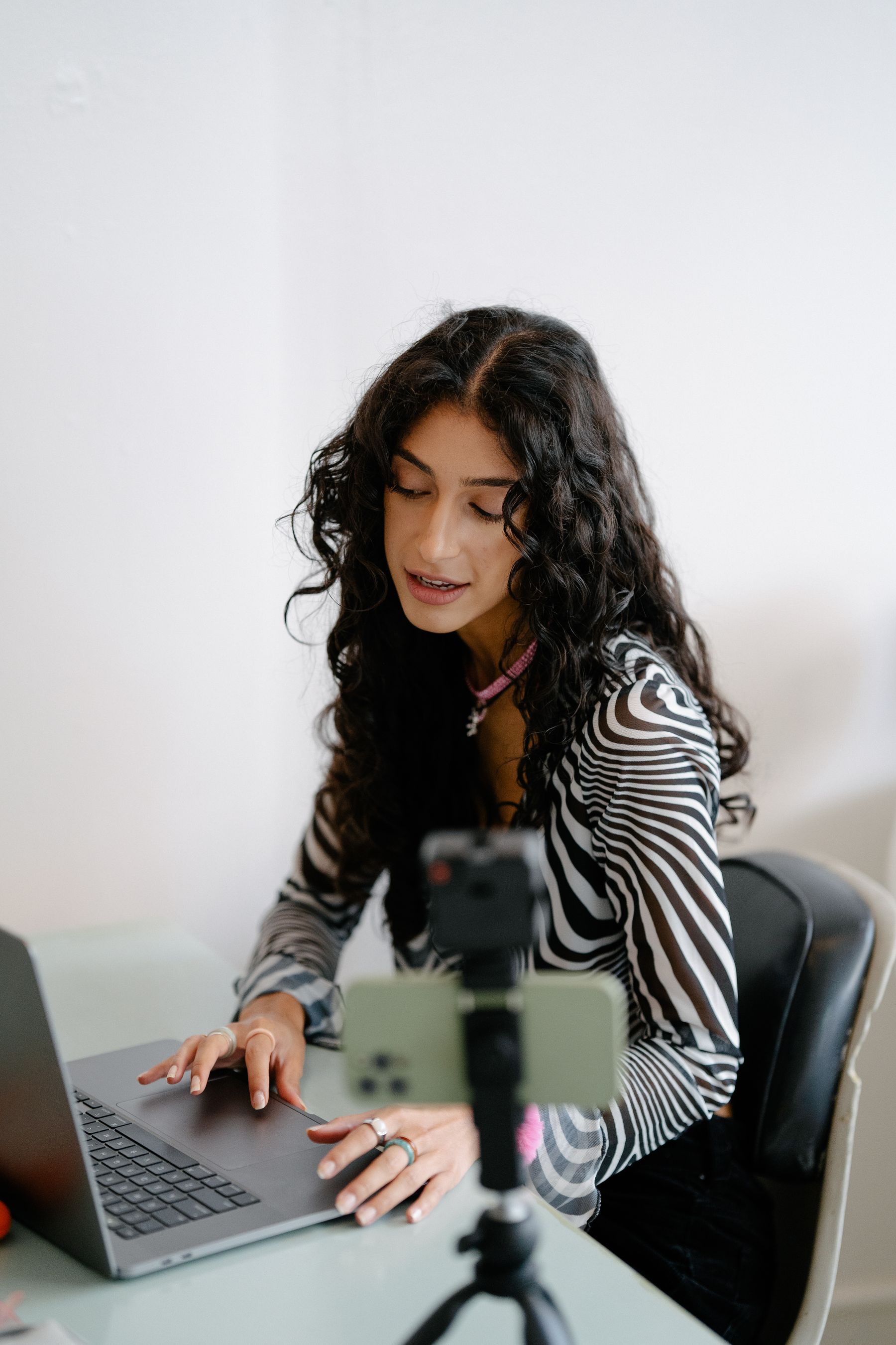 Service provider preparing for a client meeting with a laptop and smartphone